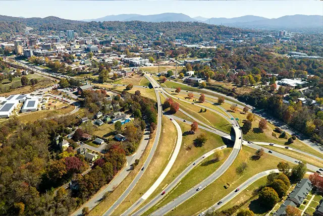 Aerial view of a highway interchange beside a town